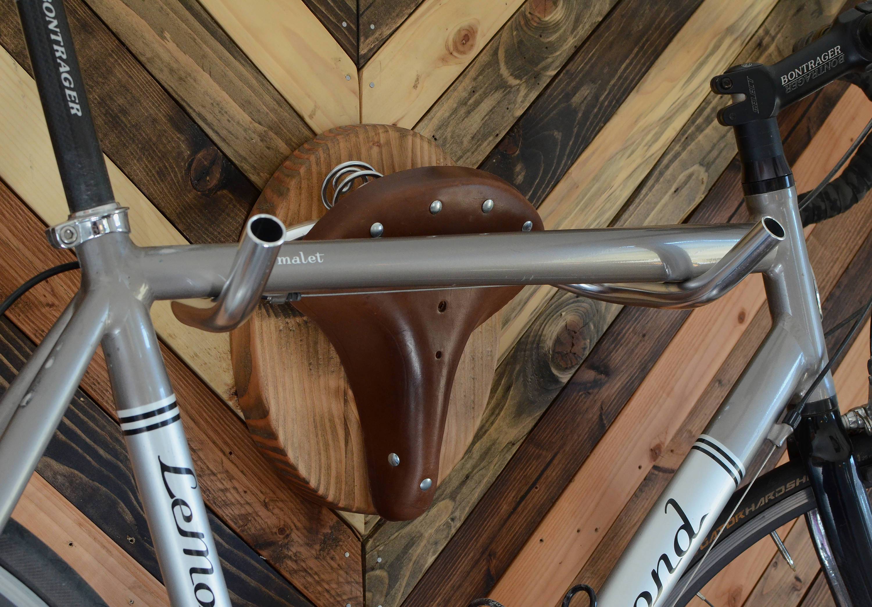 Bicycle Taxidermy Cycle Rack designed as an American Buffalo head, made from Oregon fir and leather, showcasing a bicycle.