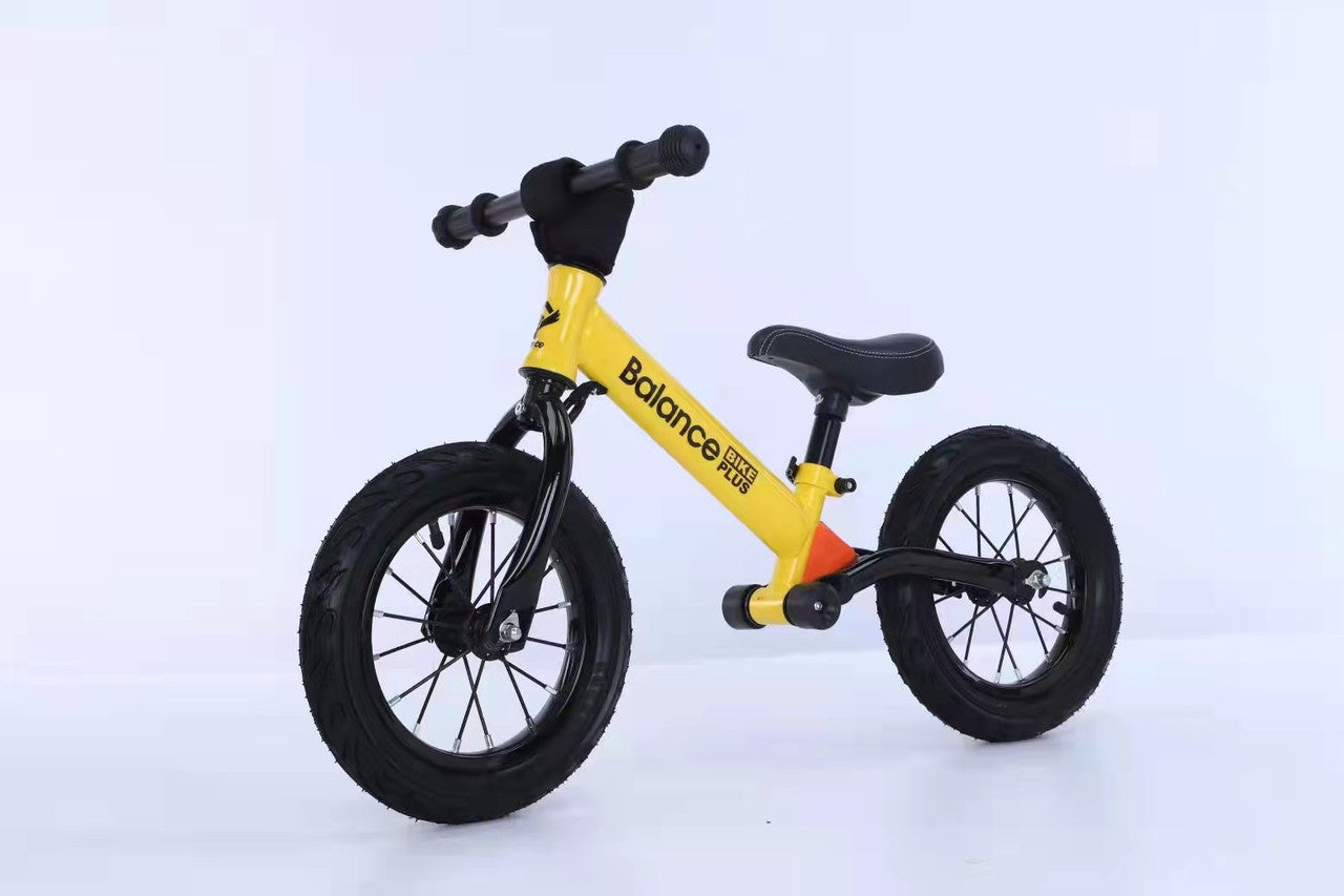 Bike Plus Kids Balance Bike in yellow, featuring a lightweight aluminum frame, 12-inch spoked wheels, and adjustable seat for children aged 2-6.