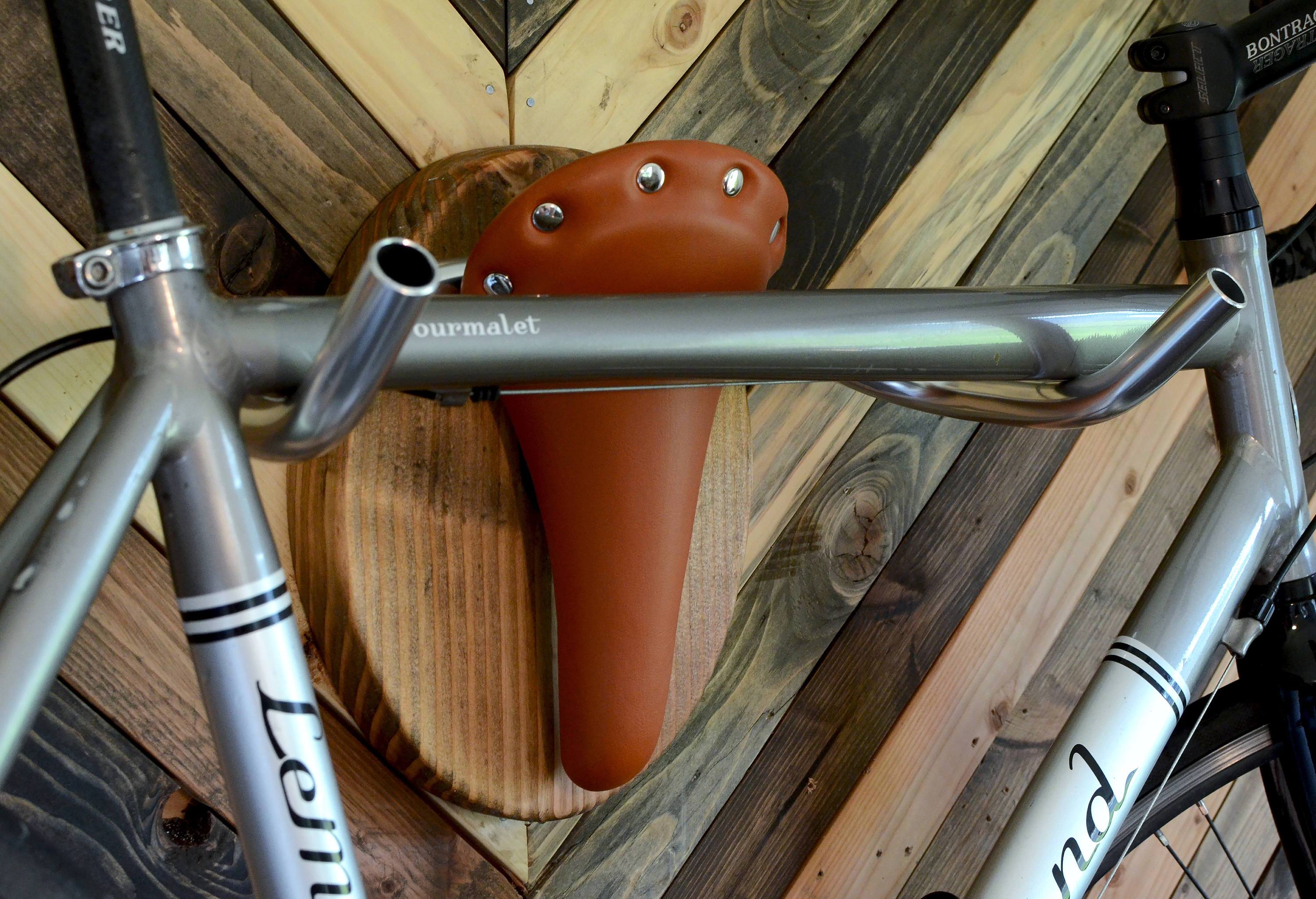 Hand-crafted Bicycle Taxidermy wall rack resembling a Texas longhorn, made from Evergreen Wood and leather.