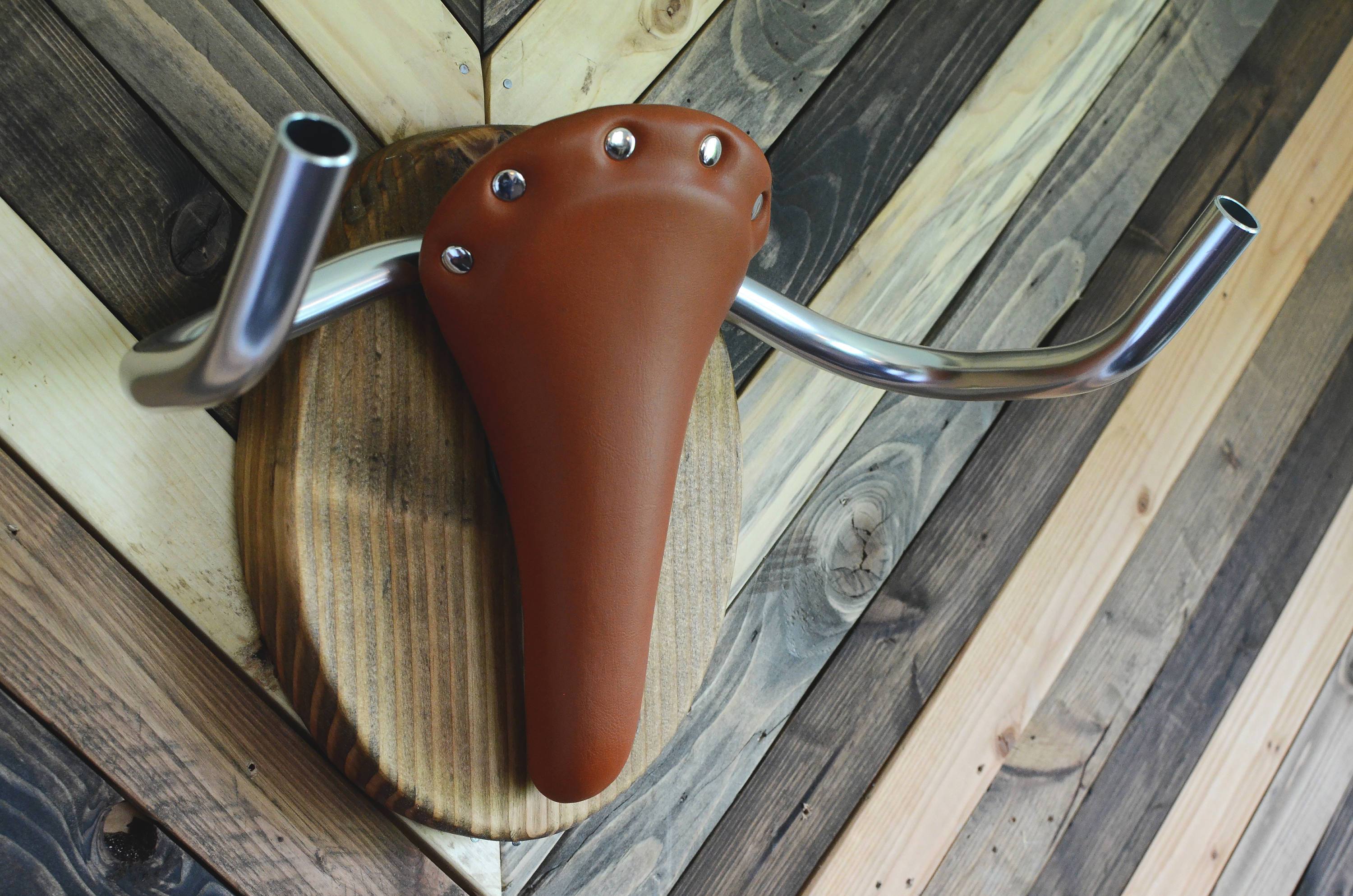 Hand-crafted Bicycle Taxidermy wall rack resembling a Texas longhorn, made from Evergreen Wood and leather.