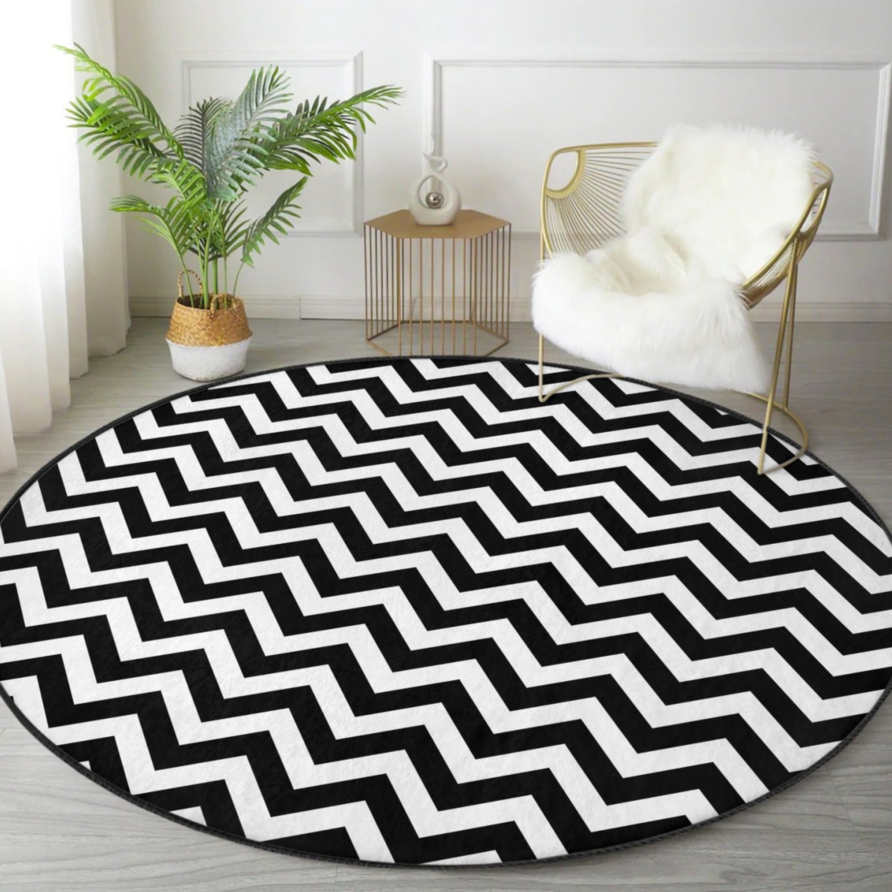 A stylish black and white round living room rug made of soft velvet fabric, showcasing a modern design suitable for various home decor styles.