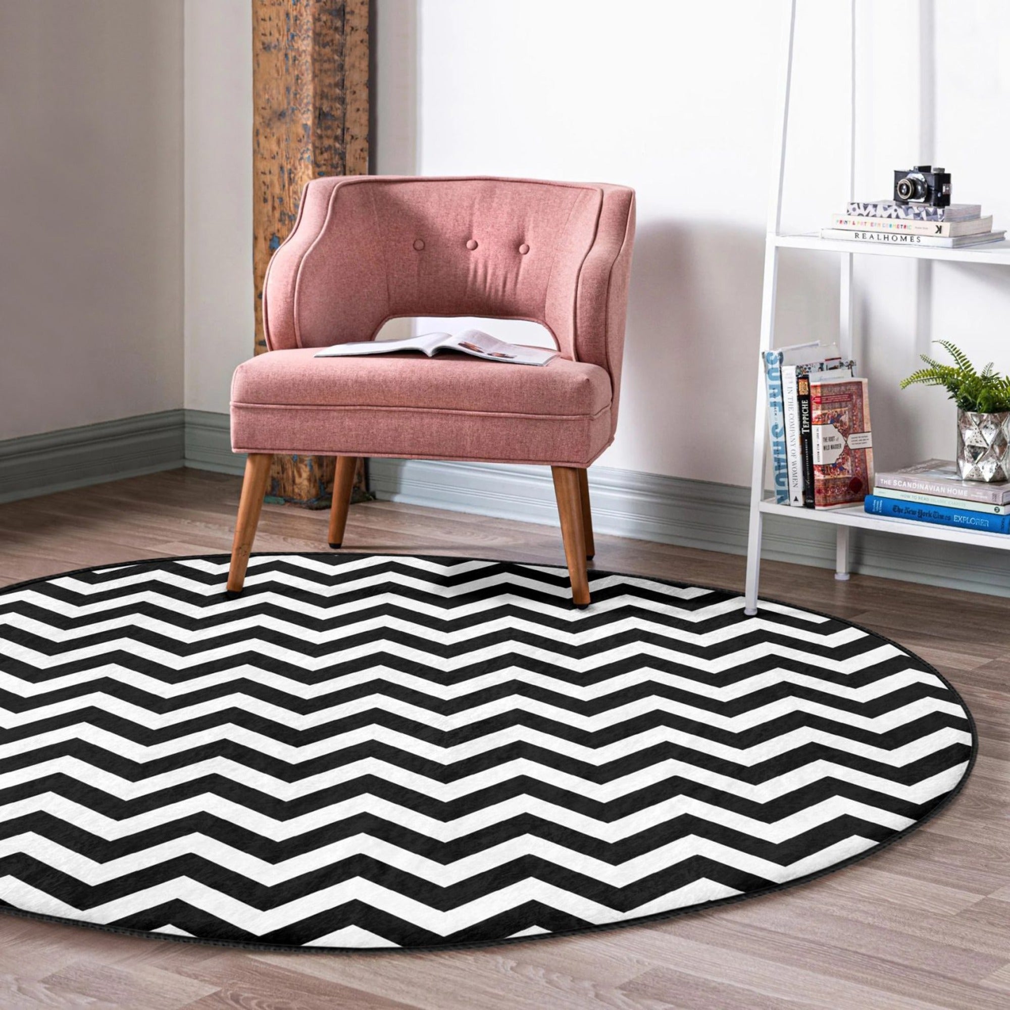 A stylish black and white round living room rug made of soft velvet fabric, showcasing a modern design suitable for various home decor styles.