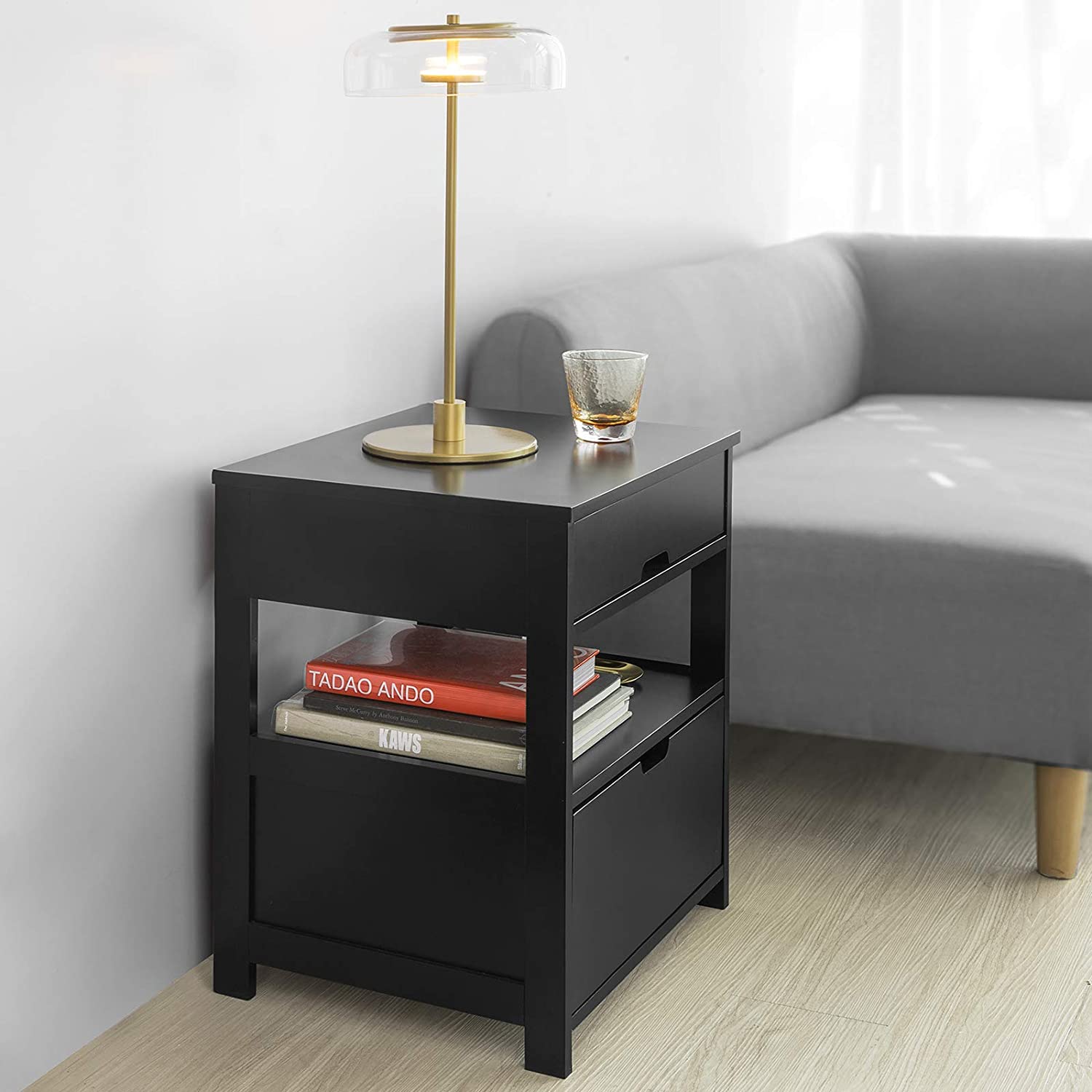 Black bedside table featuring two drawers and a shelf, designed for modern decor.