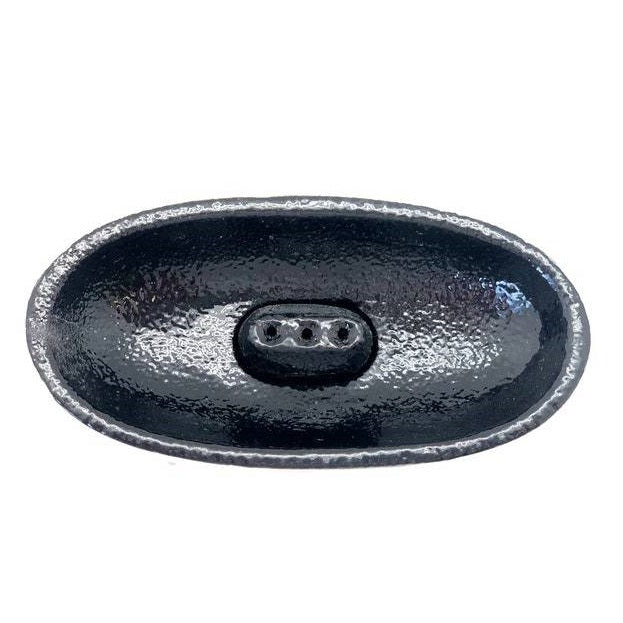 Black cast iron canoe-shaped incense smudge pot with removable holder for incense sticks and cones.