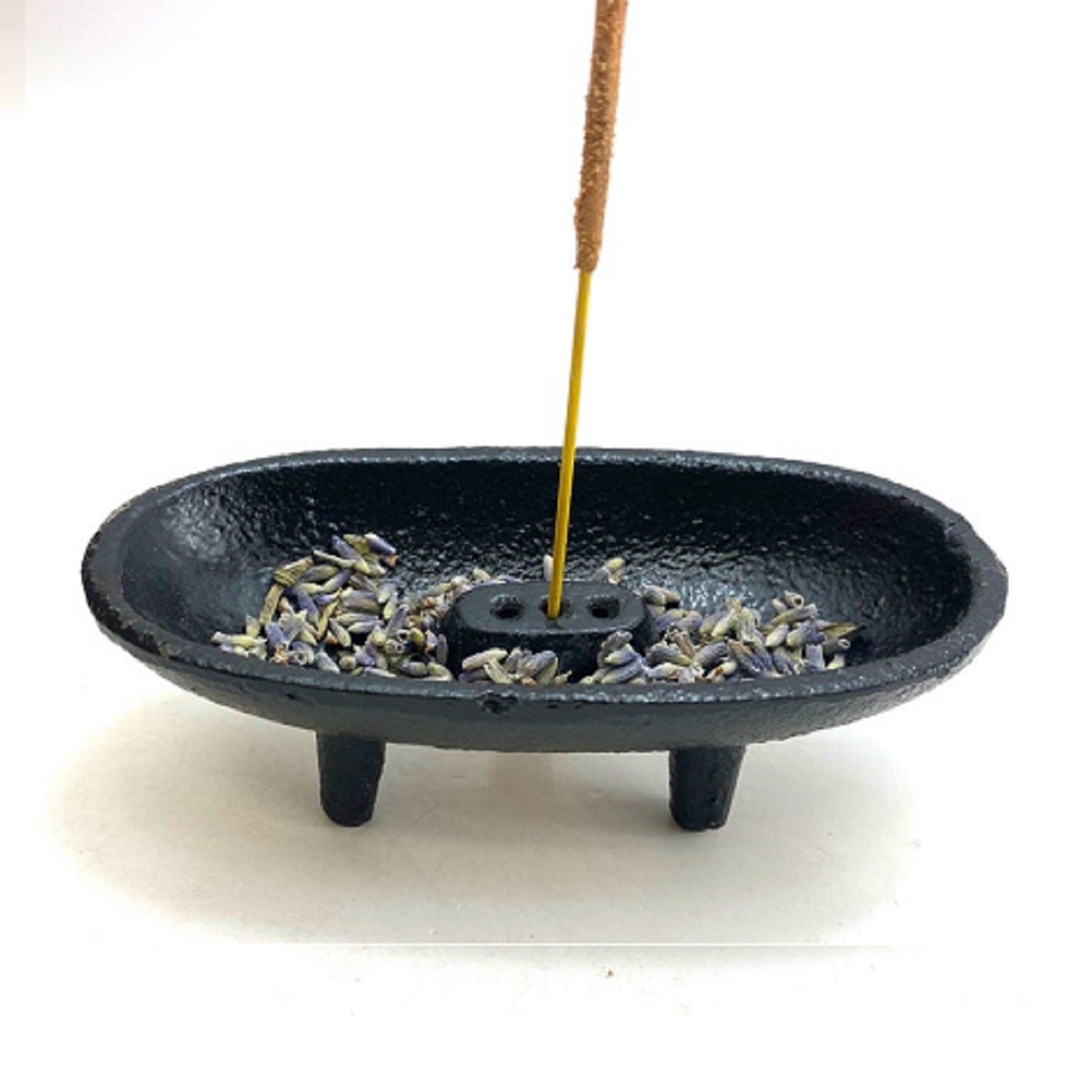 Black cast iron canoe-shaped incense smudge pot with removable holder for incense sticks and cones.