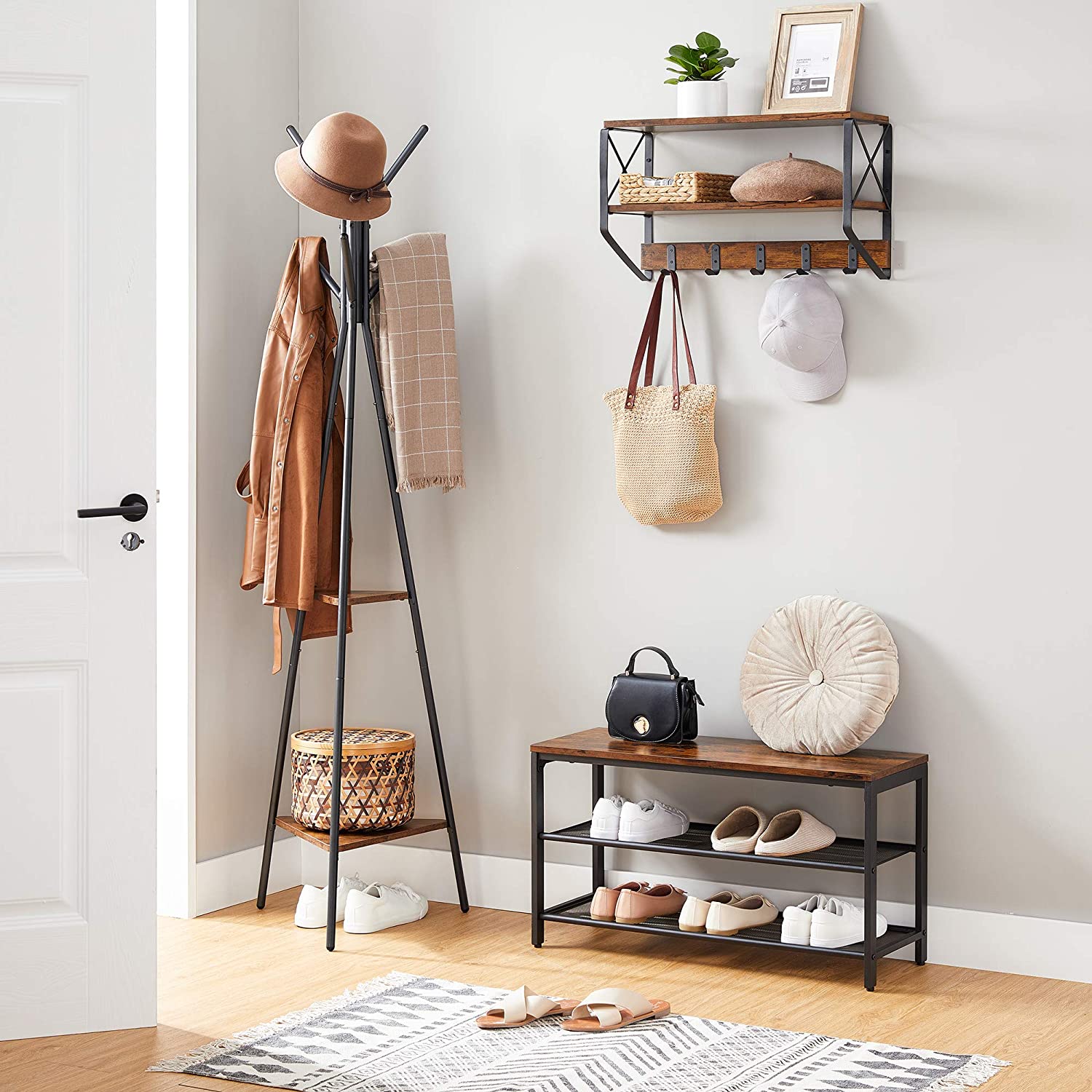 Black coat rack stand with industrial design featuring two triangular vintage shelves for added storage, perfect for minimalist home decor.