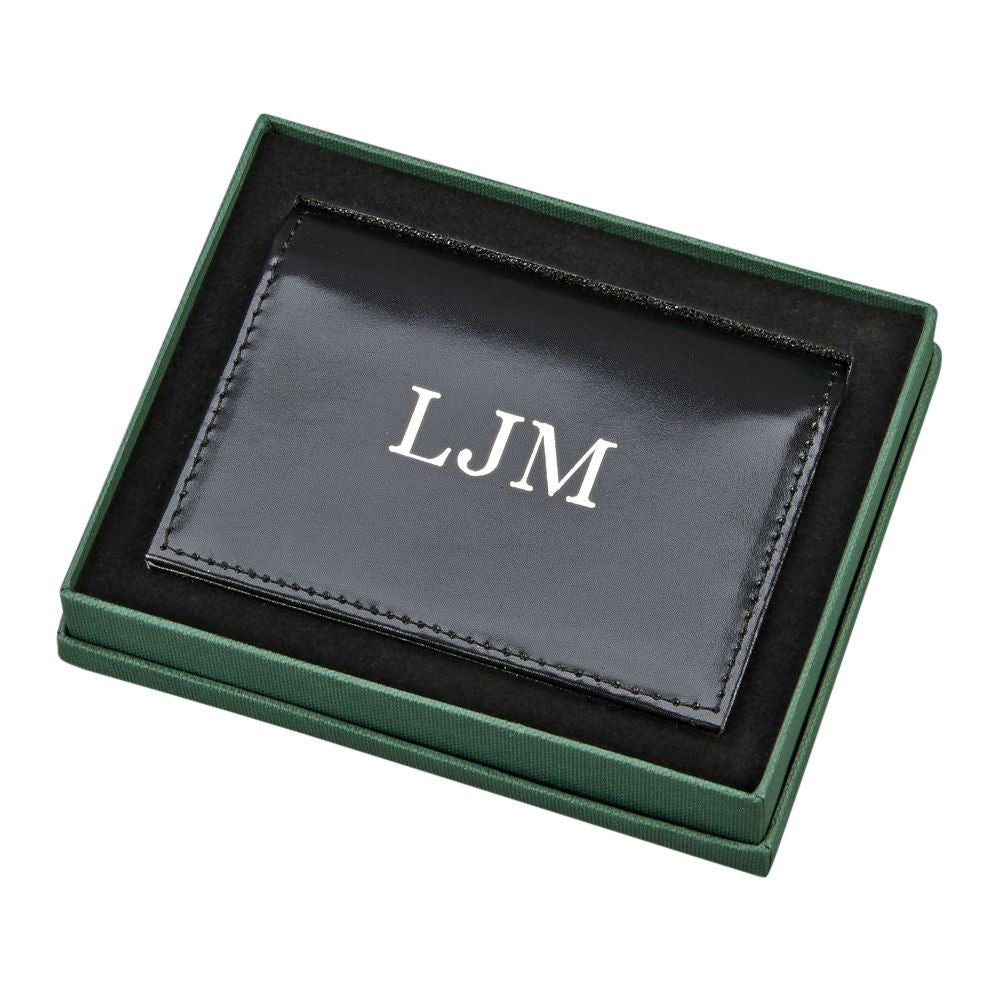 Black leather expanding card case with ID window and credit card slots, showcasing its elegant design and functionality.