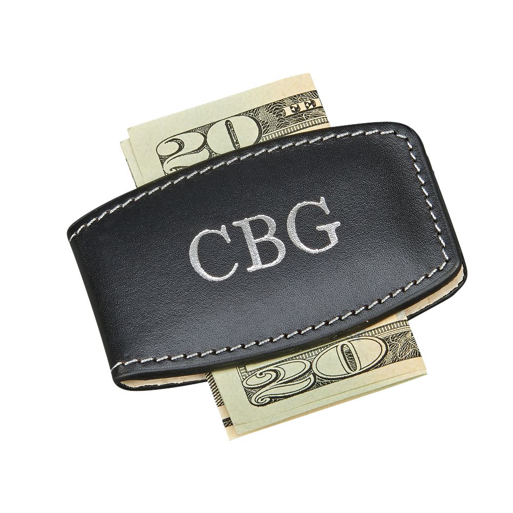 A sleek black leather money clip with embedded magnets and detailed stitching, elegantly holding cash.