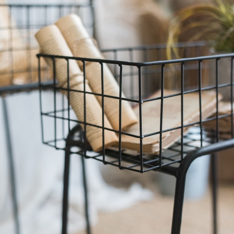 Black metal plant stand showcasing a modern design, perfect for indoor and outdoor use.