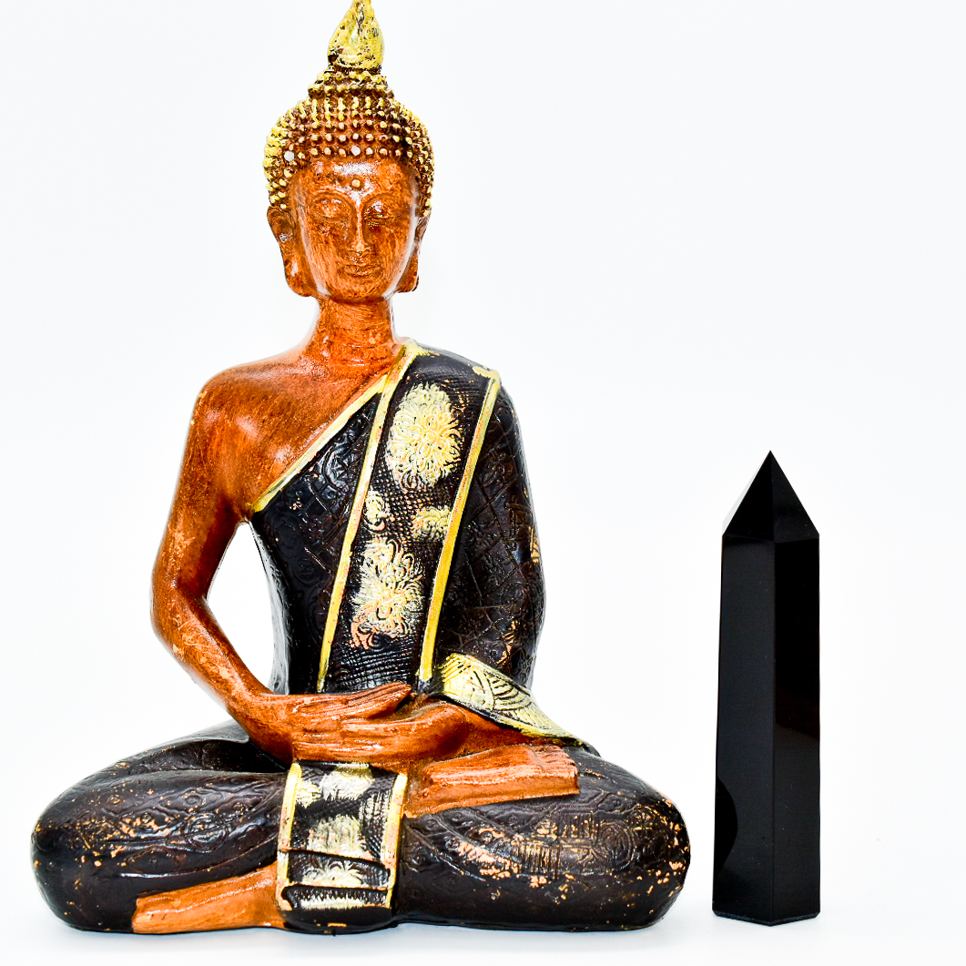 A tall Black Onyx Crystal Point, showcasing its deep black color and smooth surface, perfect for meditation and decor.