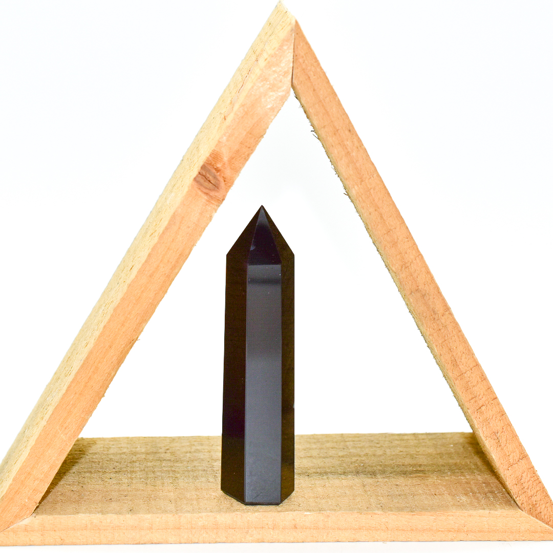 A tall Black Onyx Crystal Point, showcasing its deep black color and smooth surface, perfect for meditation and decor.