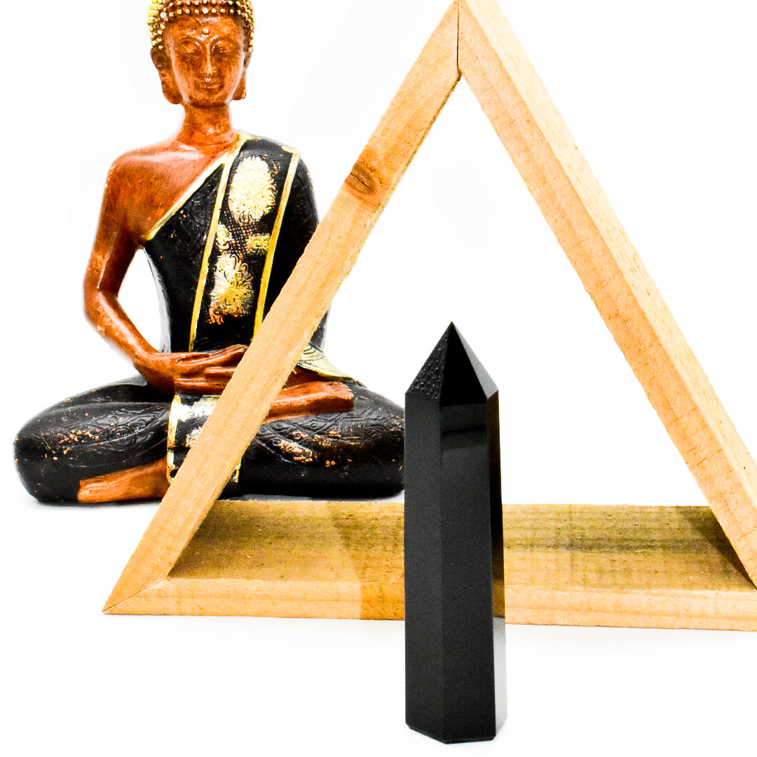 A polished Black Onyx Crystal Point standing 4 inches tall, showcasing its sleek black surface and pointed tip, ideal for meditation and decor.