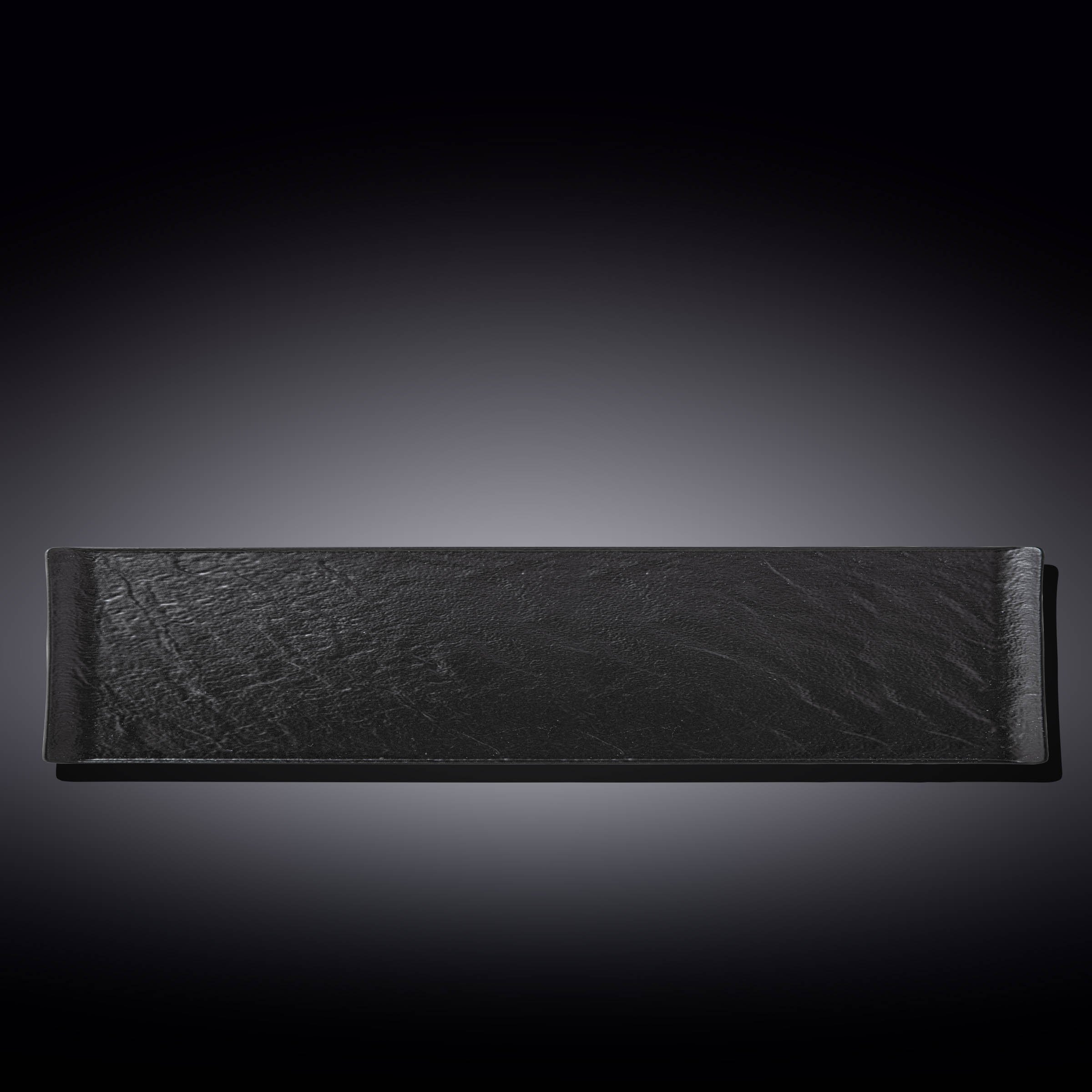 Black rectangular porcelain dish with a slate look, measuring 18.25 inches by 3.75 inches, ideal for elegant food presentations.