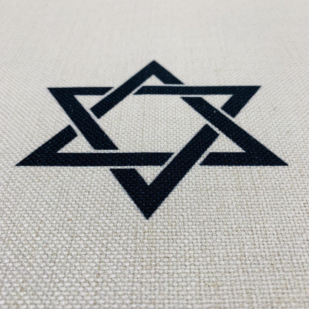 Elegant Black Shabbat Shalom tablecloth featuring Hebrew and English stripes, Magen David and Hamsa details, made from linen-cotton blend.