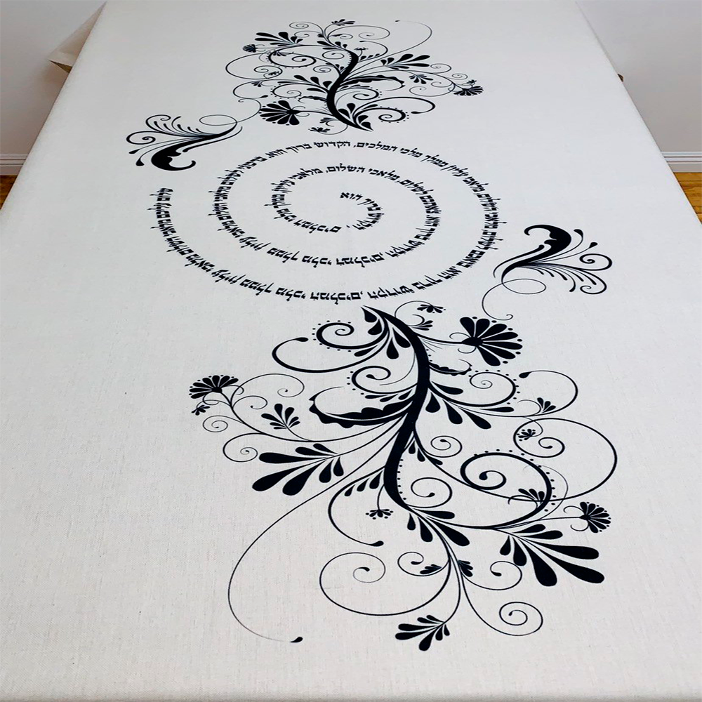 Luxurious Black Shalom Aleichem tablecloth featuring intricate swirls and floral designs, perfect for Shabbat dinners.