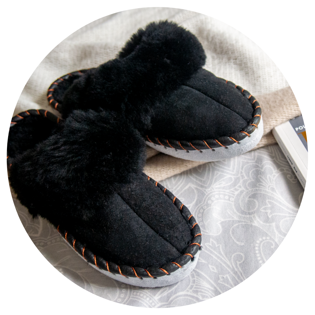 Elegant black shearling sheepskin mules, handcrafted with natural sheepskin and leather, showcasing a stylish and comfortable design.