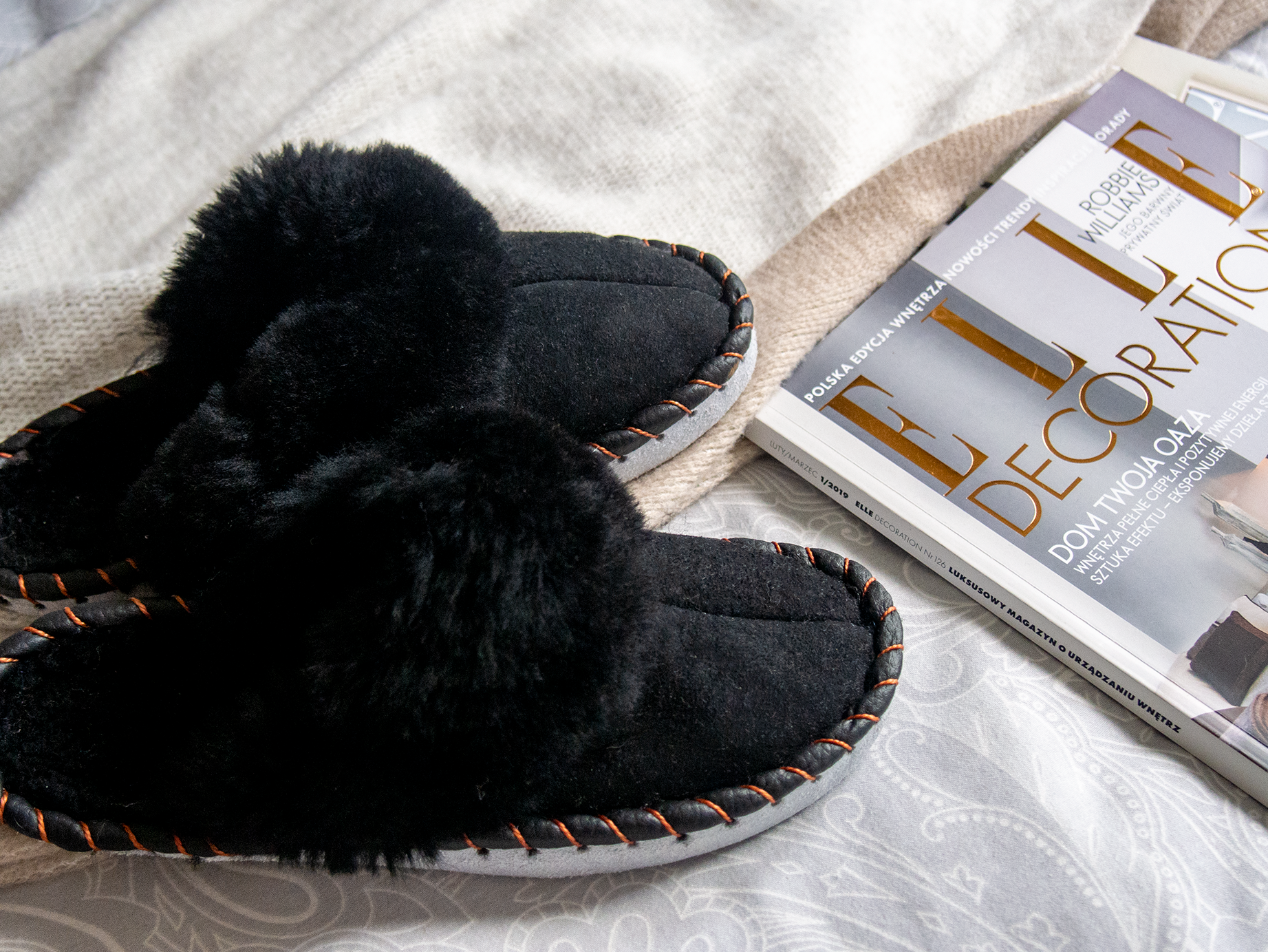 Elegant black shearling sheepskin mules, handcrafted with natural sheepskin and leather, showcasing a stylish and comfortable design.