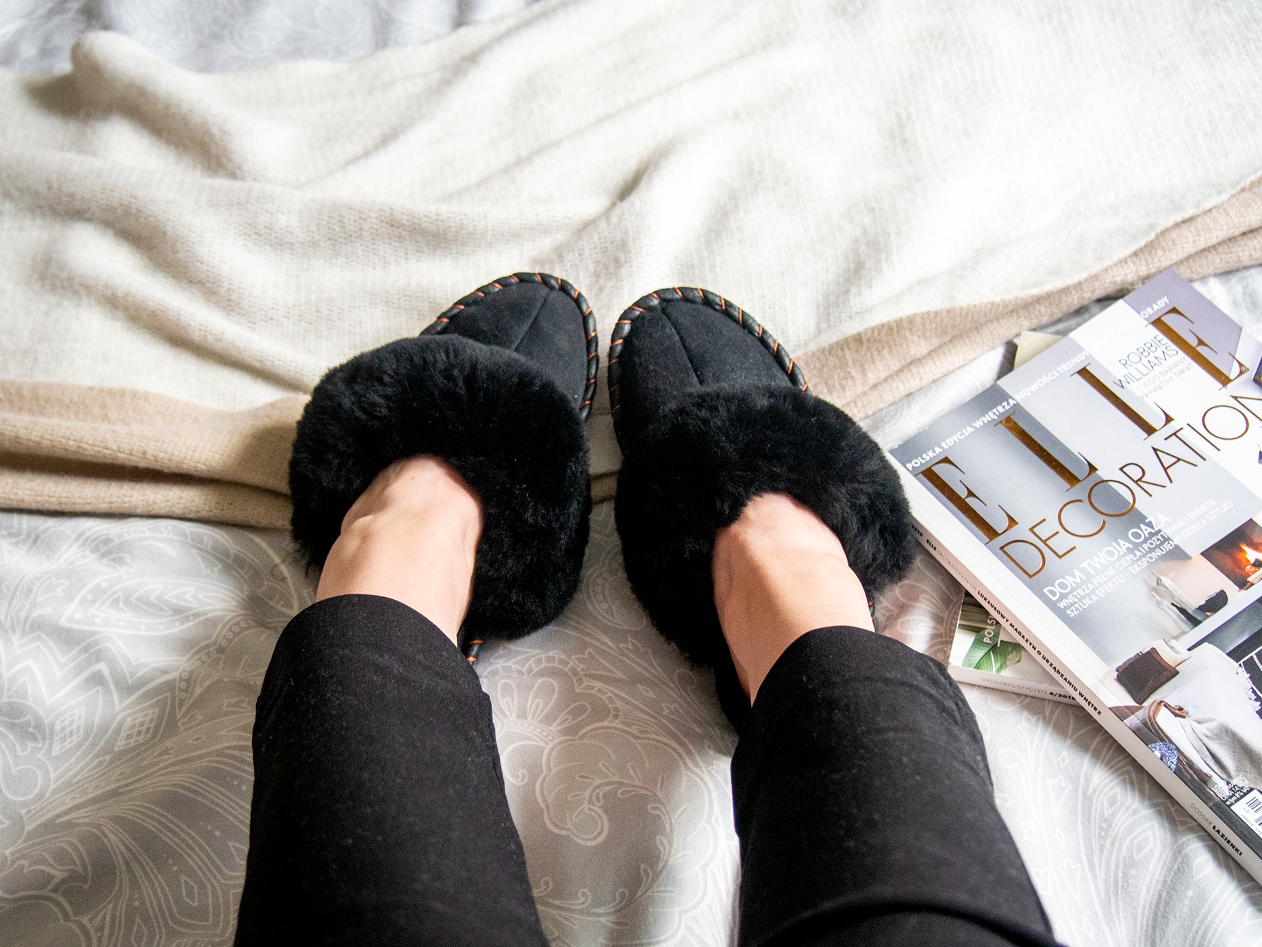 Elegant black shearling sheepskin mules, handcrafted with natural sheepskin and leather, showcasing a stylish and comfortable design.