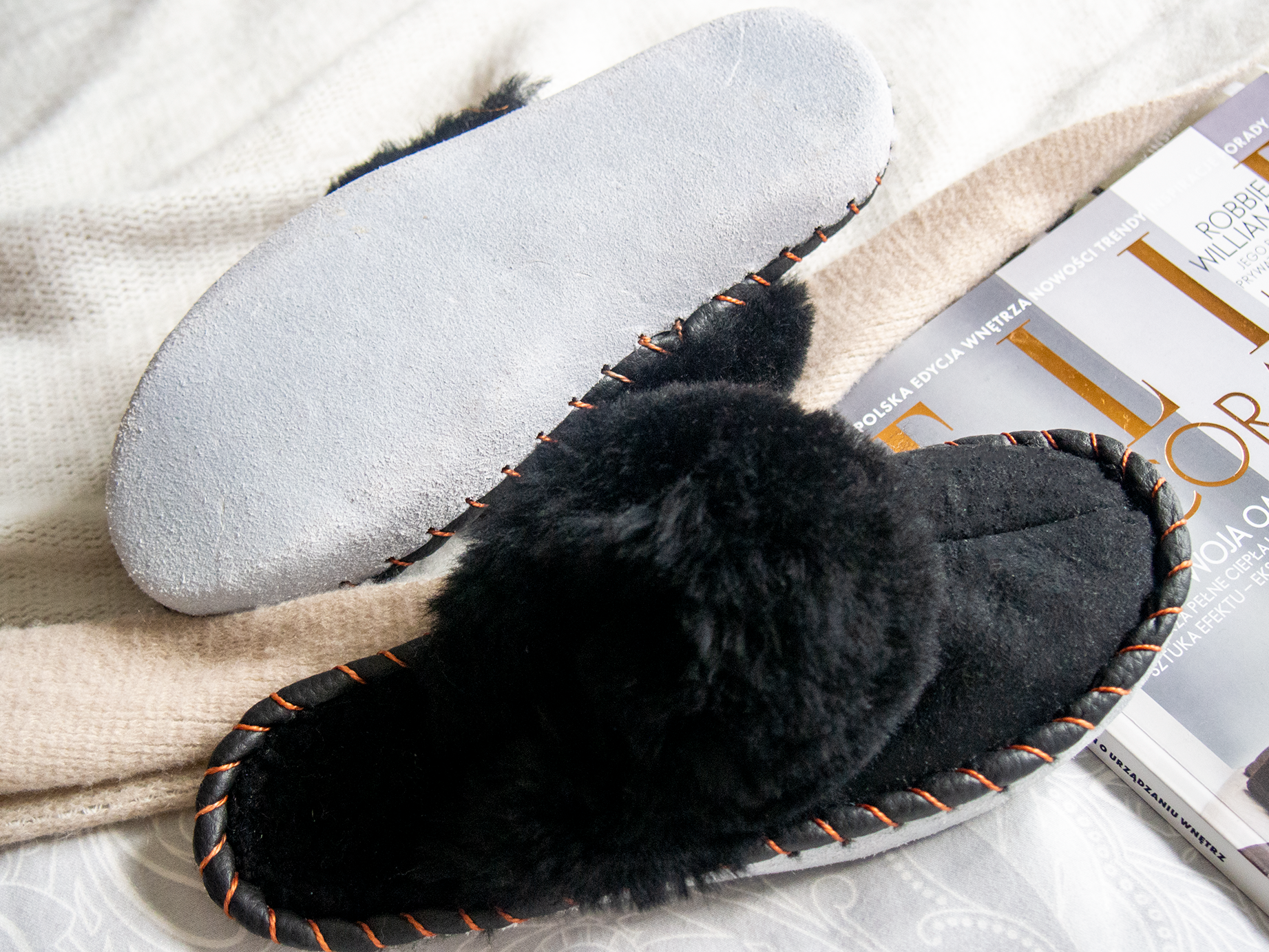 Elegant black shearling sheepskin mules, handcrafted with natural sheepskin and leather, showcasing a stylish and comfortable design.