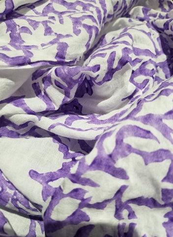 Bright and beautiful block printed paisley fabric in pink and purple, made from soft cotton, showcasing intricate designs.