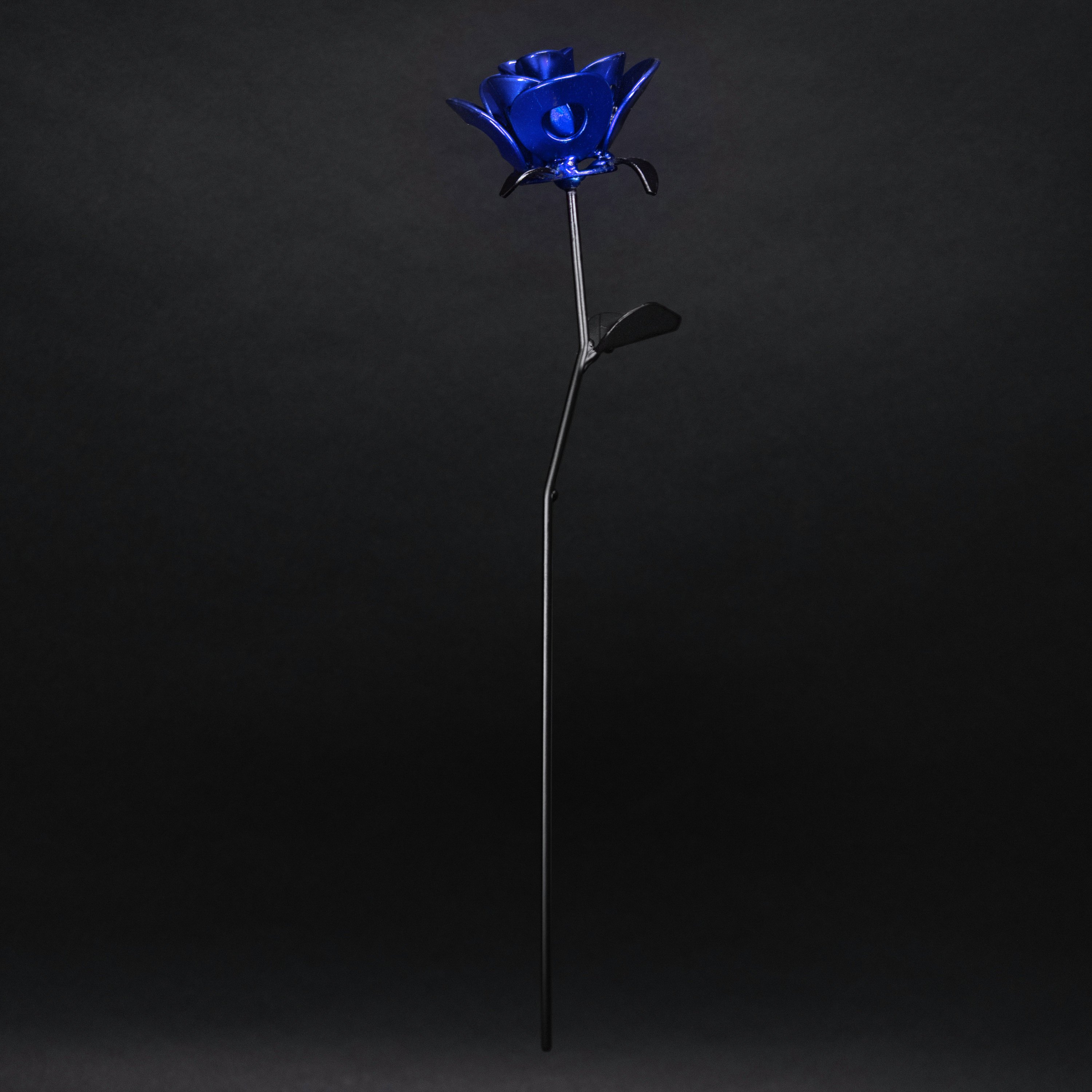 A handcrafted blue and black metal rose made from recycled materials, showcasing intricate welded details and a lustrous finish.