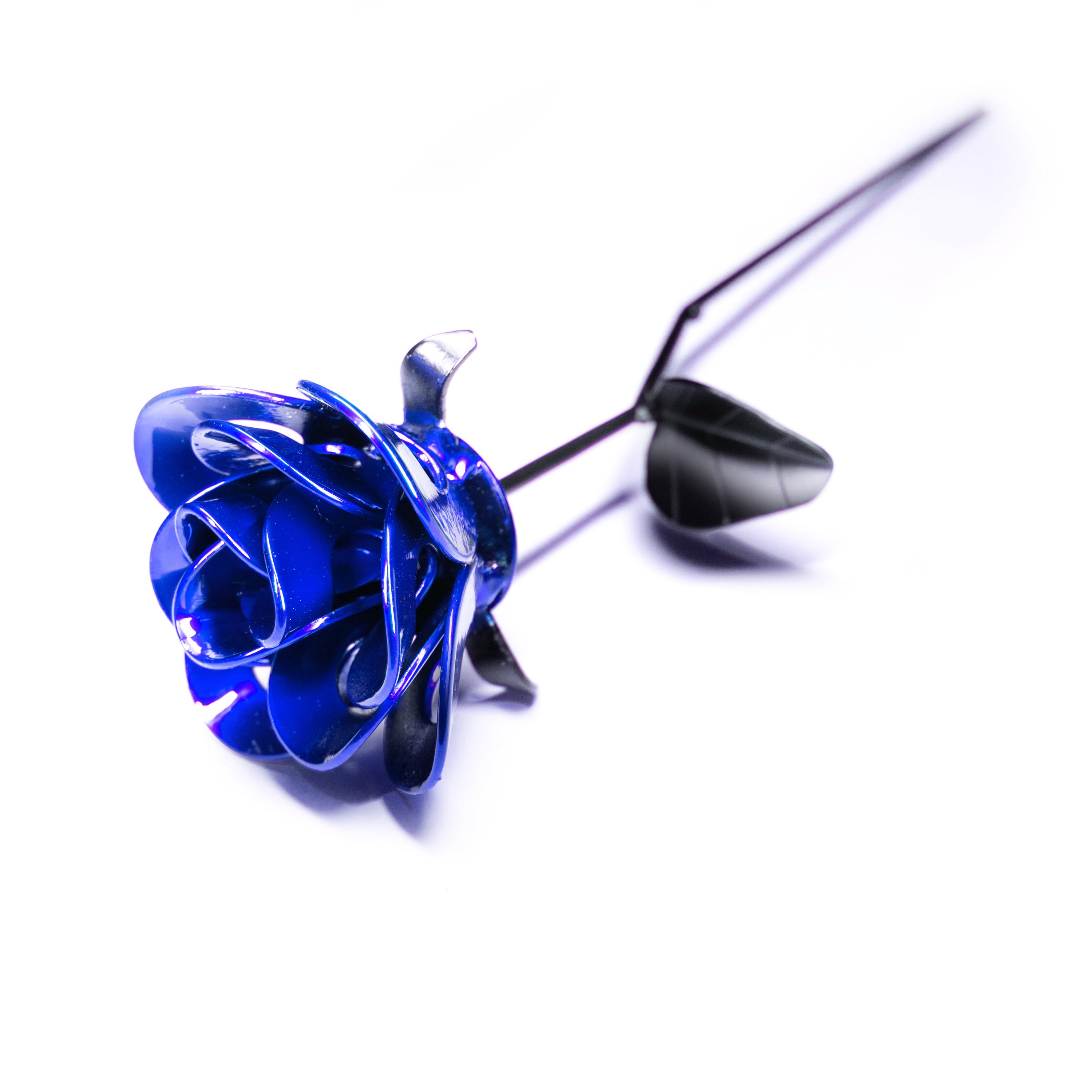 A handcrafted blue and black metal rose made from recycled materials, showcasing intricate welded details and a lustrous finish.