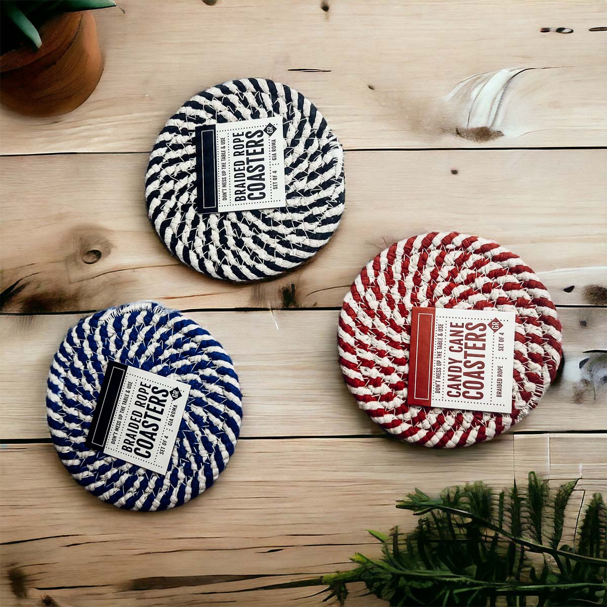 Set of four blue braided coasters with a candy cane stripe pattern, perfect for protecting surfaces and adding festive decor.