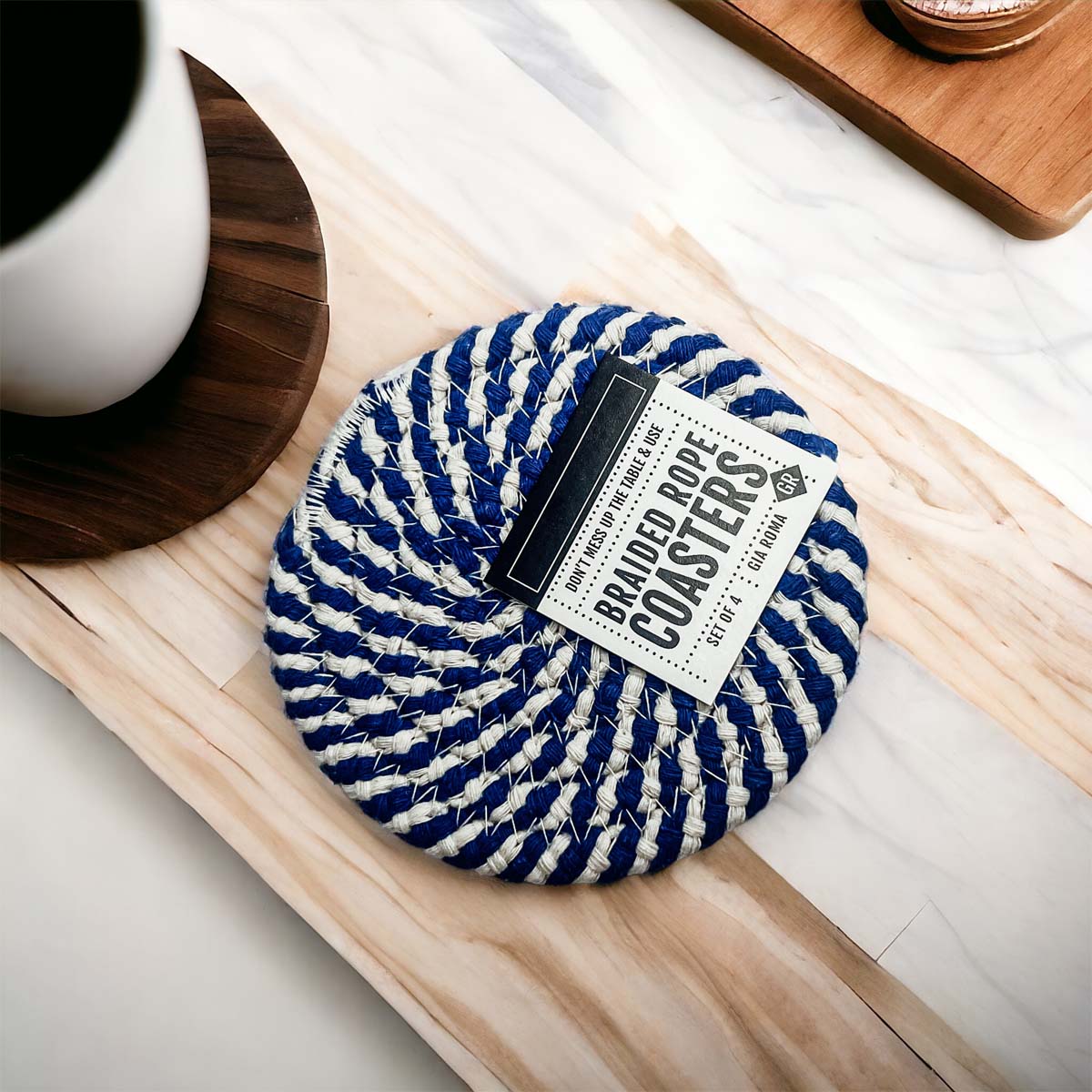 Set of four blue braided coasters with a candy cane stripe pattern, perfect for protecting surfaces and adding festive decor.