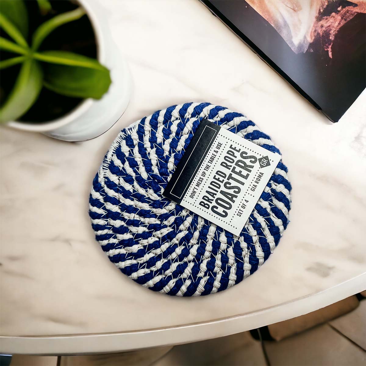 Set of four blue braided coasters with a candy cane stripe pattern, perfect for protecting surfaces and adding festive decor.