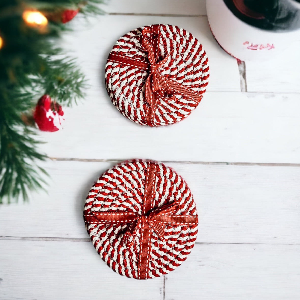 Set of four blue braided coasters with a candy cane stripe pattern, perfect for protecting surfaces and adding festive decor.