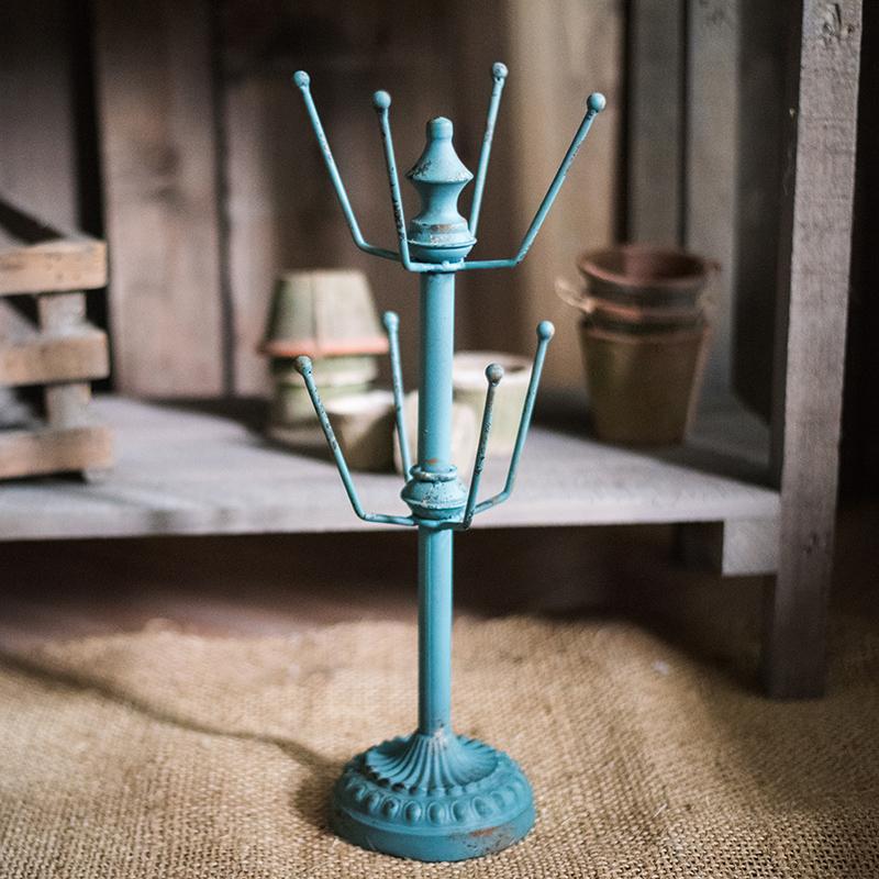 A stylish blue metal cup holder planter holder, showcasing vibrant colors and a modern design, perfect for indoor and outdoor use.