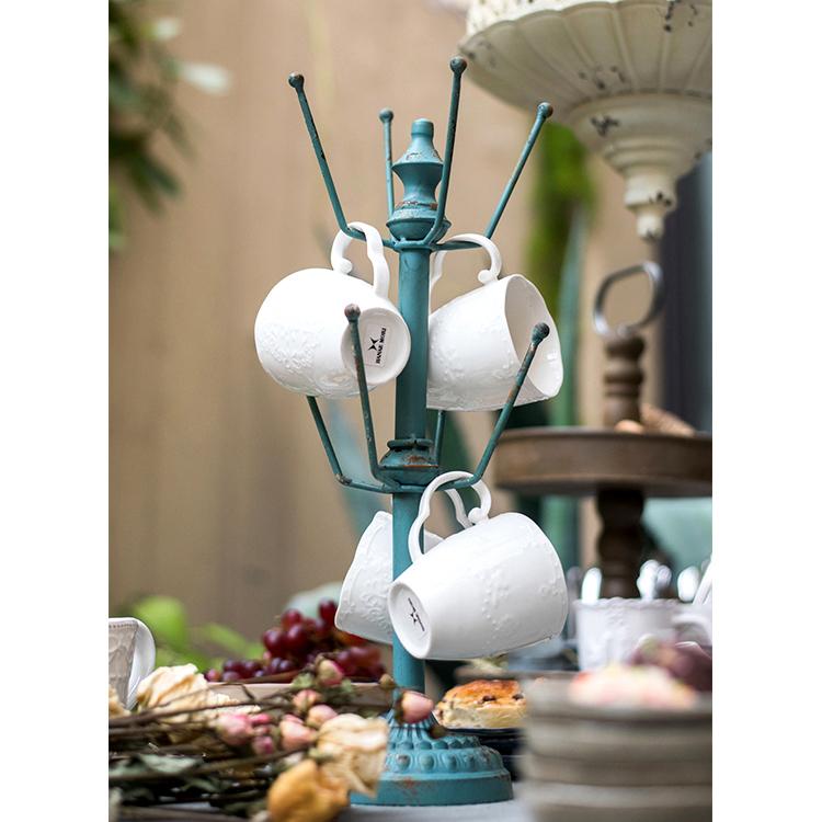 A stylish blue metal cup holder planter holder, showcasing vibrant colors and a modern design, perfect for indoor and outdoor use.