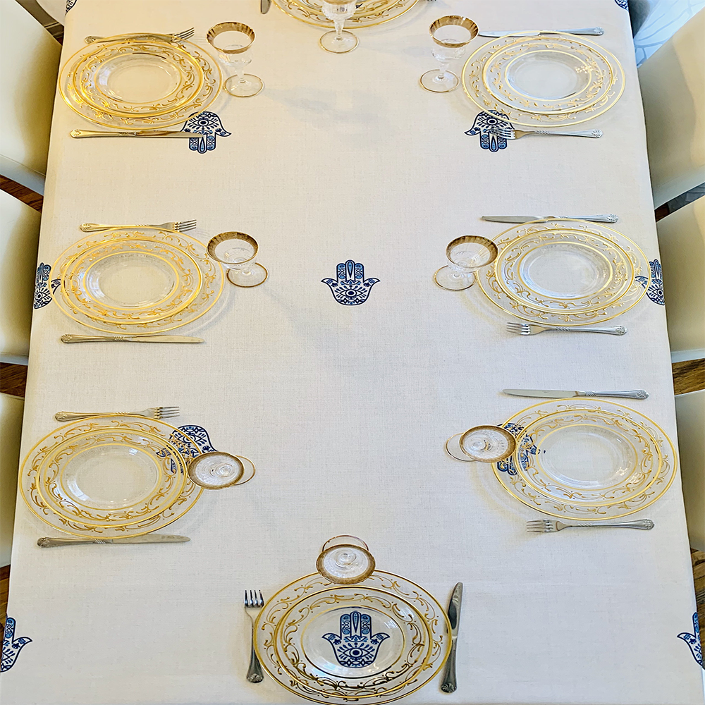 Blue Hamsa Tablecloth featuring an original Ella design by Broderies de France, showcasing a blue-eyed Hamsa symbol.