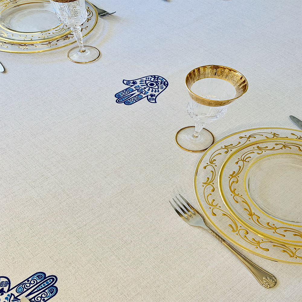 Blue Hamsa Tablecloth featuring an original Ella design by Broderies de France, showcasing a blue-eyed Hamsa symbol.