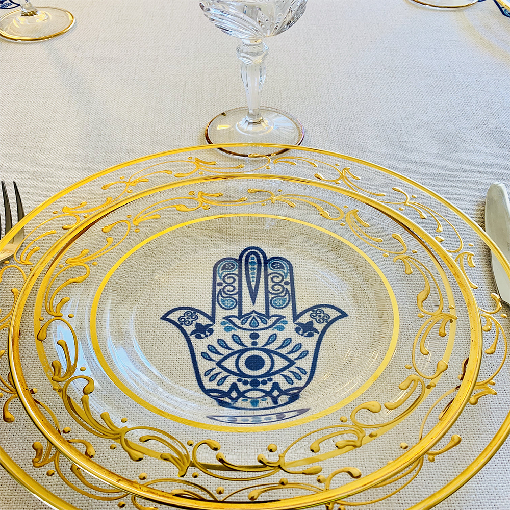 Blue Hamsa Tablecloth featuring an original Ella design by Broderies de France, showcasing a blue-eyed Hamsa symbol.