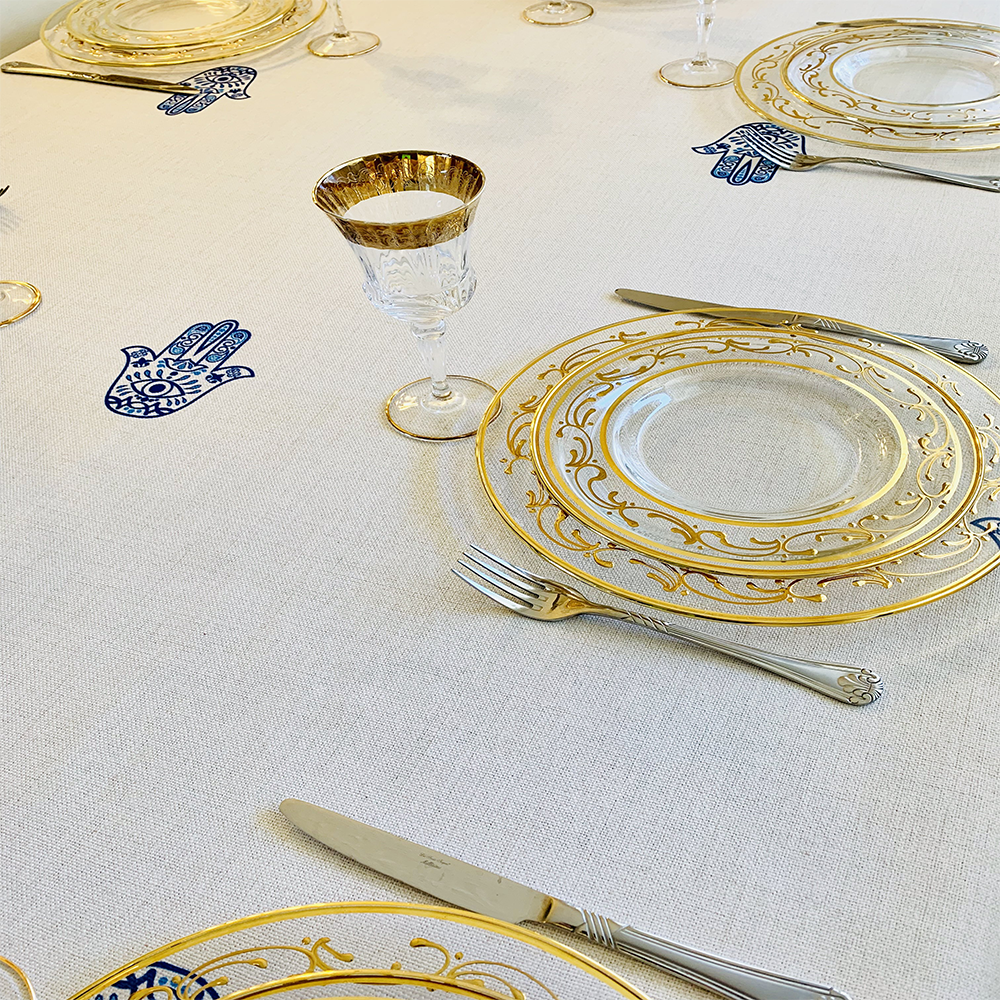 Blue Hamsa Tablecloth featuring an original Ella design by Broderies de France, showcasing a blue-eyed Hamsa symbol.