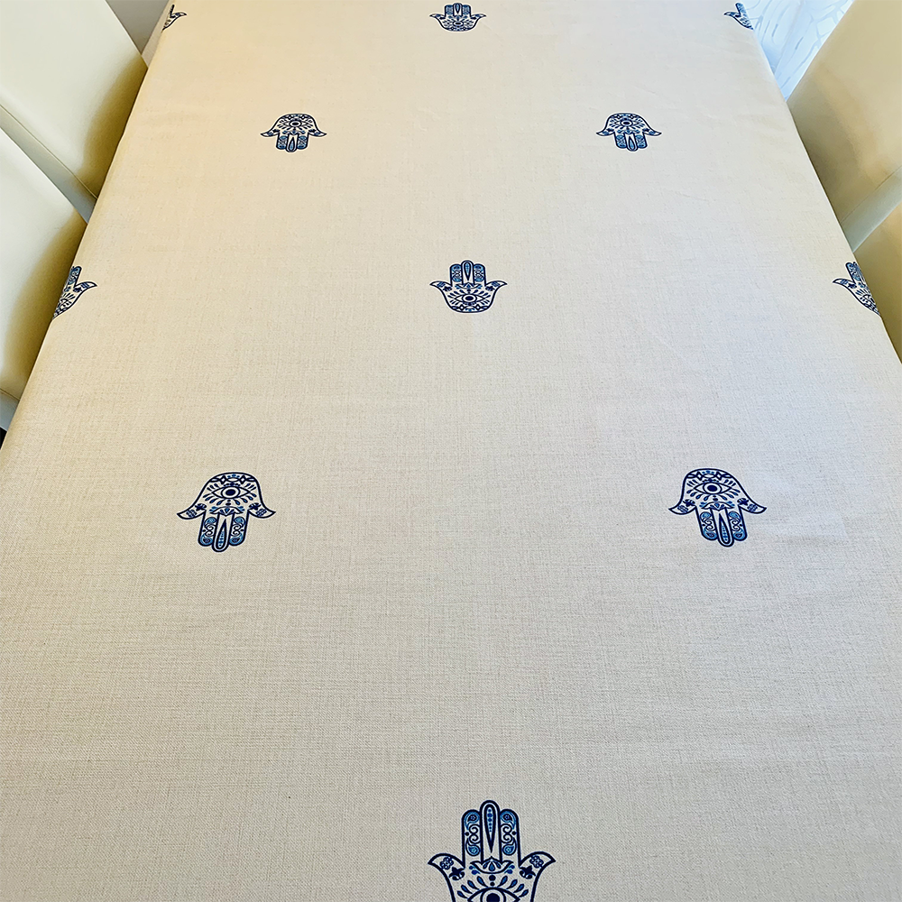 Blue Hamsa Tablecloth featuring an original Ella design by Broderies de France, showcasing a blue-eyed Hamsa symbol.