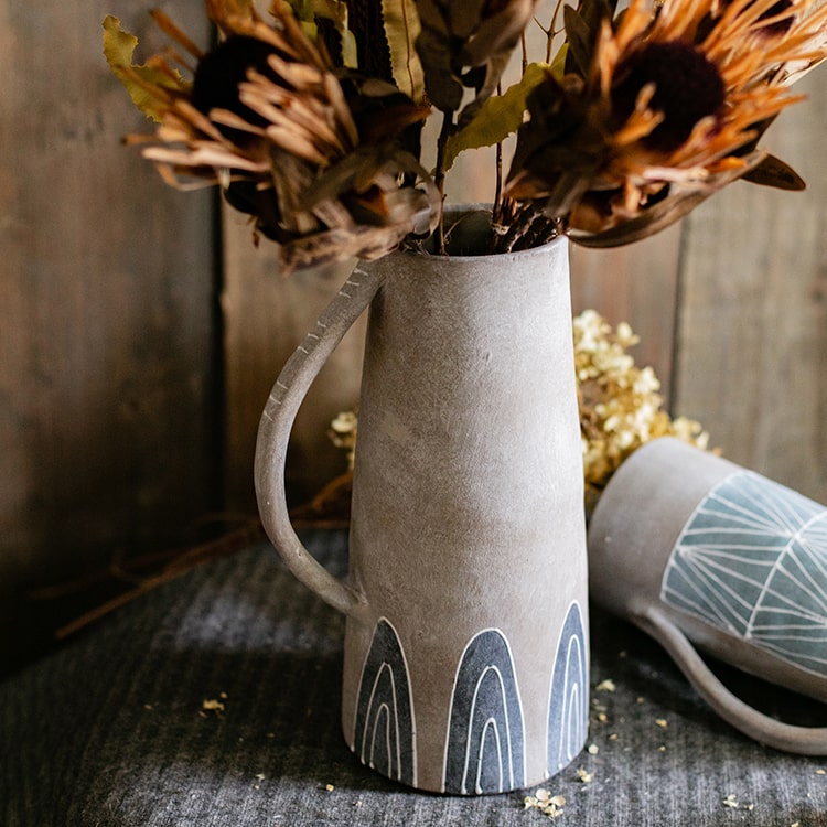 A beautifully handpainted blue terracotta vase jar with intricate designs, showcasing its unique colors and craftsmanship.