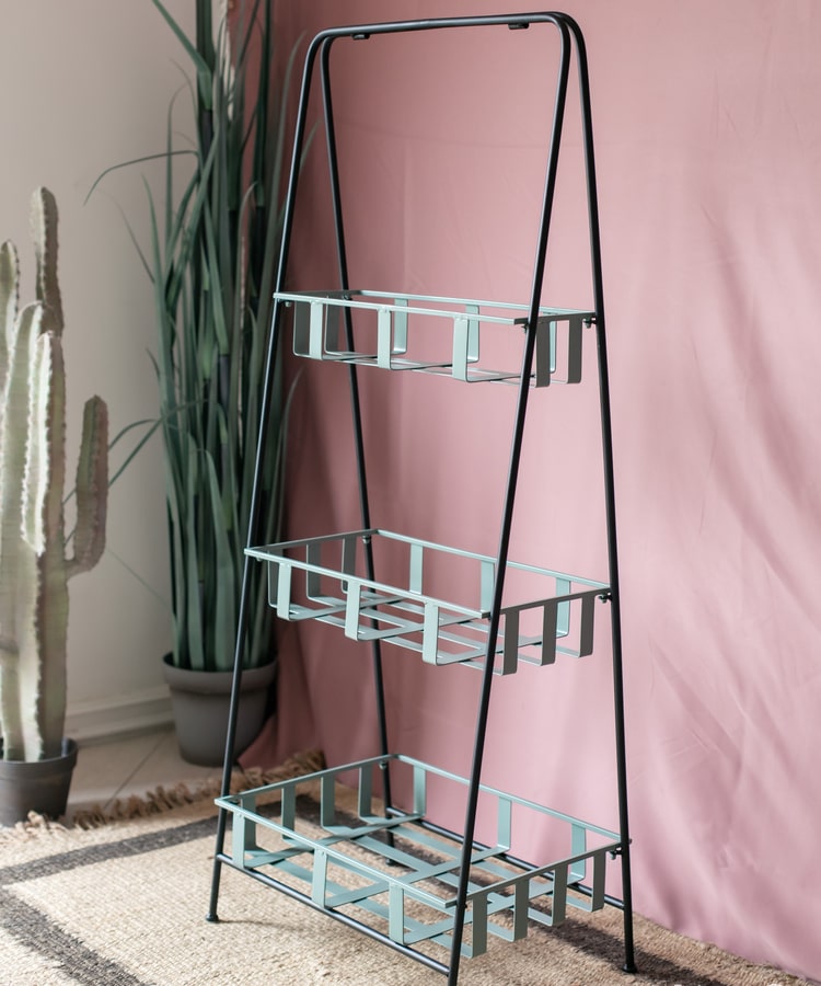 A rustic blue metal shelf with three tiered baskets, showcasing a vintage design perfect for home decor.