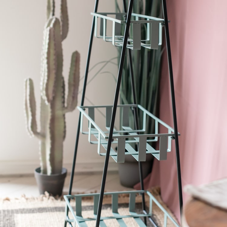 A rustic blue metal shelf with three tiered baskets, showcasing a vintage design perfect for home decor.