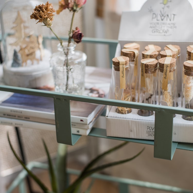 A rustic blue metal shelf with three tiered baskets, showcasing a vintage design perfect for home decor.