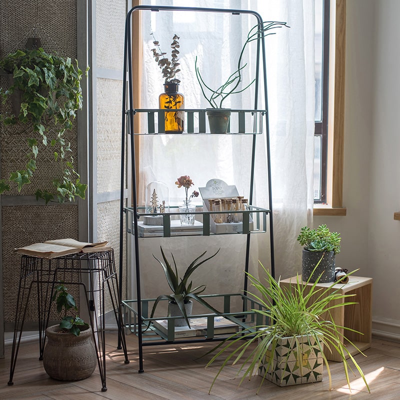 A rustic blue metal shelf with three tiered baskets, showcasing a vintage design perfect for home decor.