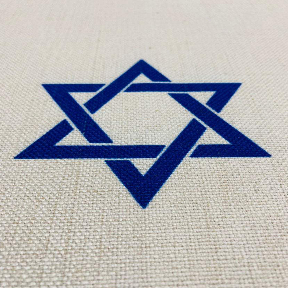 Blue Shabbat Shalom tablecloth featuring Hebrew and English stripes with Magen David and Hamsa designs, made from linen-cotton blend.