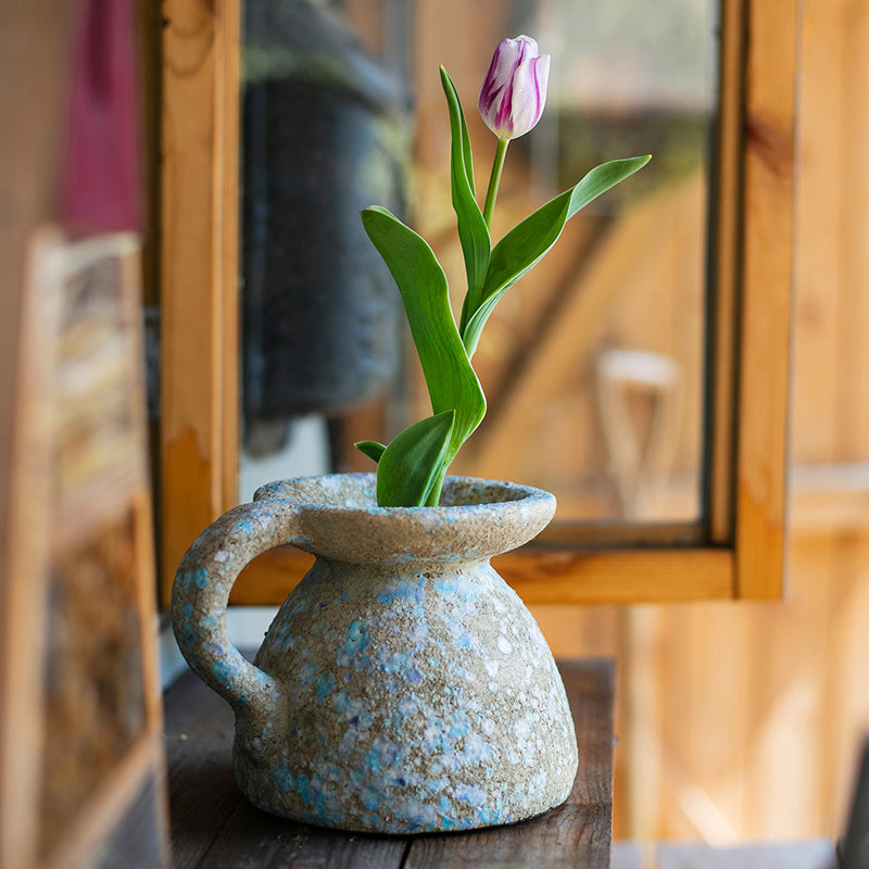 A beautifully handcrafted blue terracotta table vase, showcasing unique colors and design, perfect for home decor.