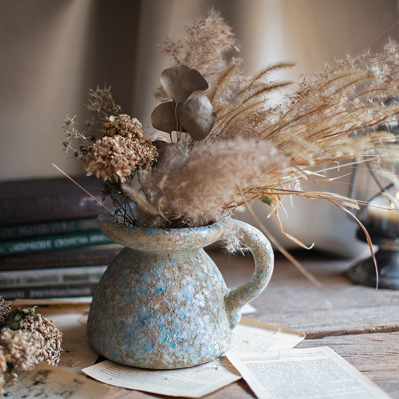 A beautifully handcrafted blue terracotta table vase, showcasing unique colors and design, perfect for home decor.