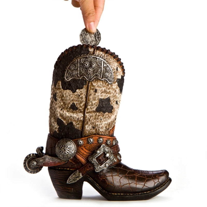 A rustic cowboy boot-shaped money bank with snakeskin detailing and a worn leather look, perfect for home decor.