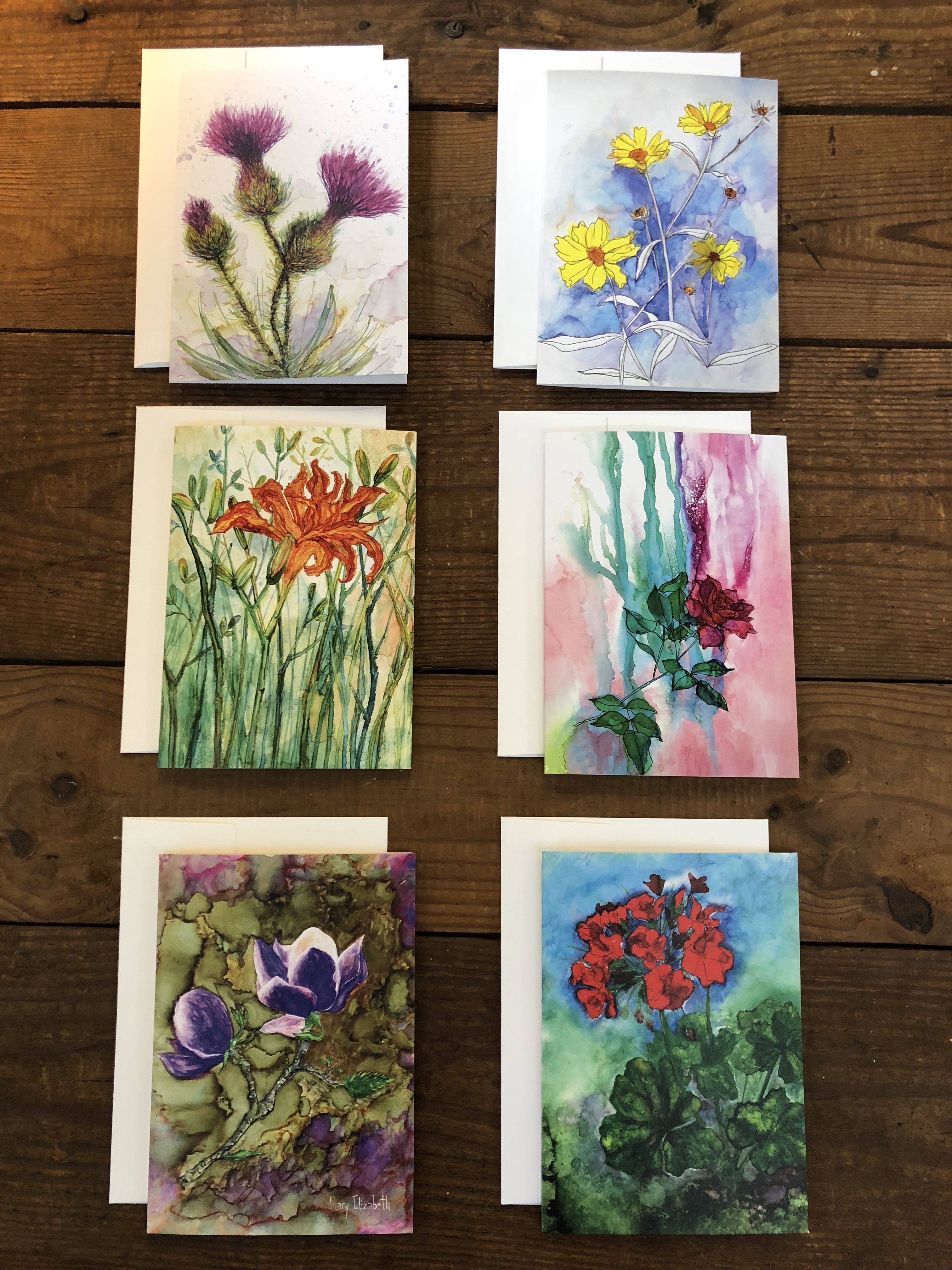 A beautifully arranged box set of 6 greeting cards featuring original flower paintings including Thistles, Daylily, Rose, and Magnolia.