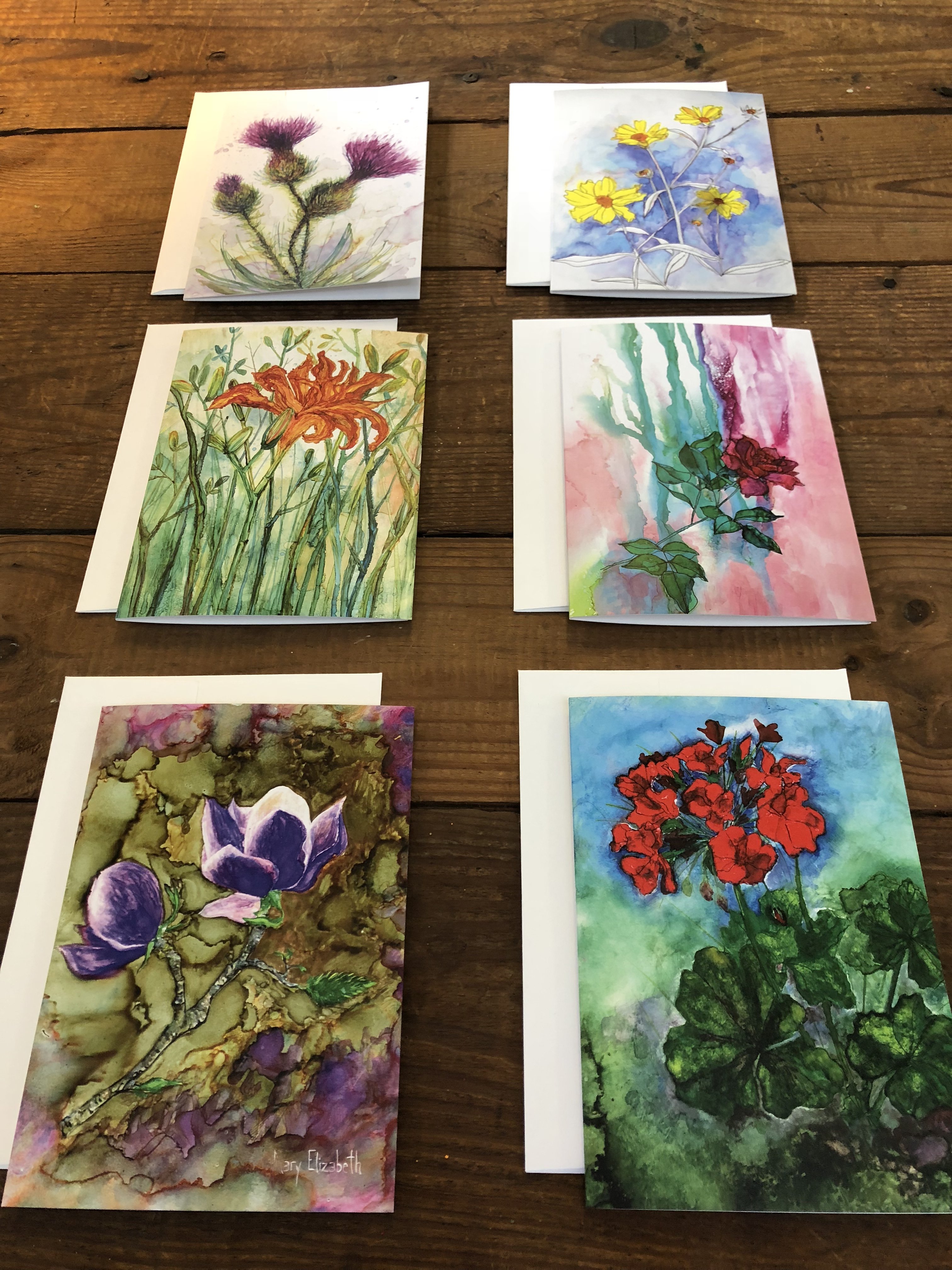 A beautifully arranged box set of 6 greeting cards featuring original flower paintings including Thistles, Daylily, Rose, and Magnolia.