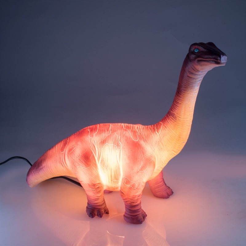 A whimsical Brachiosaurus table lamp with a soft glow, perfect for children's rooms.