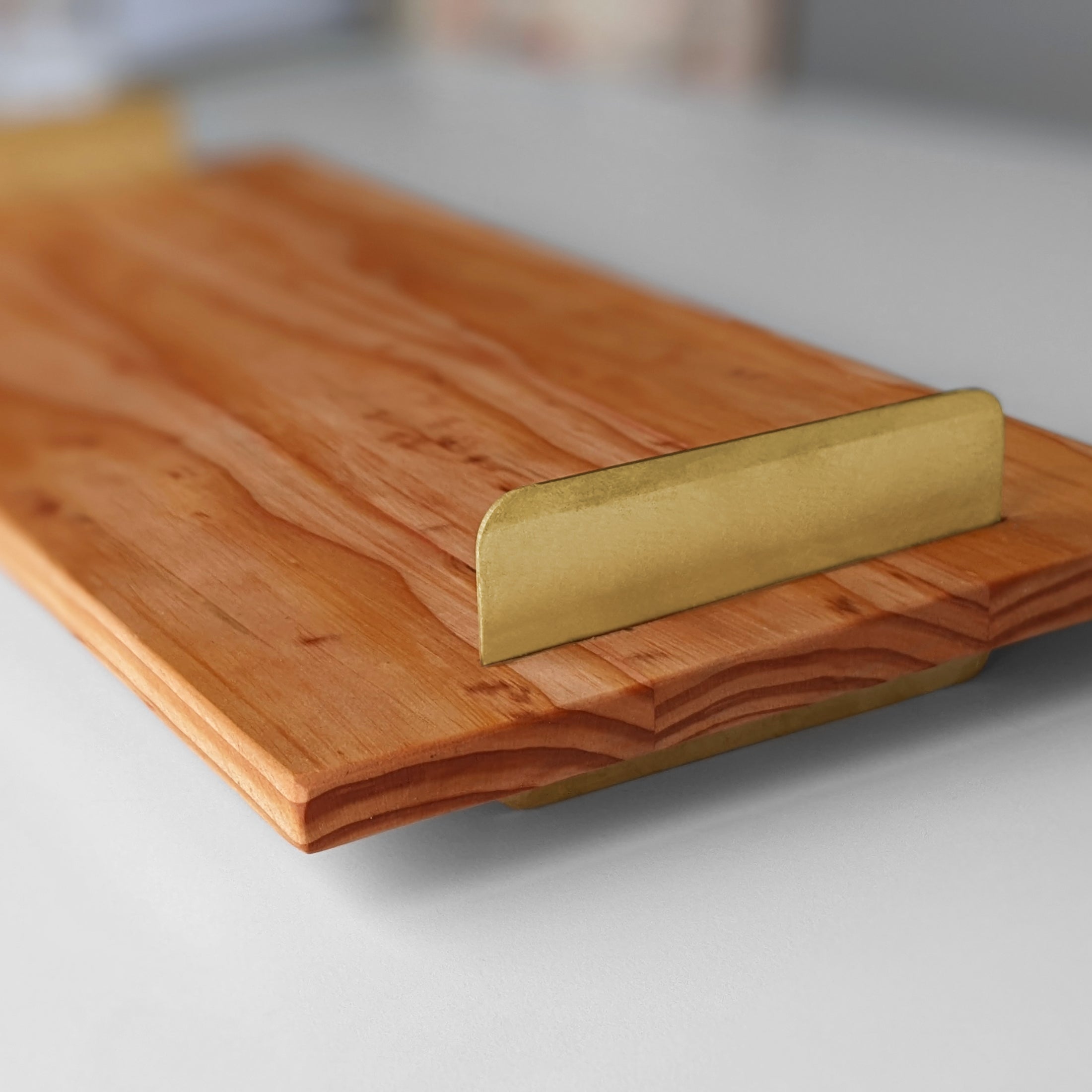 A beautifully crafted Brass Handle Tray made from Doug Fir wood with elegant brass handles, showcasing a unique beeswax finish.